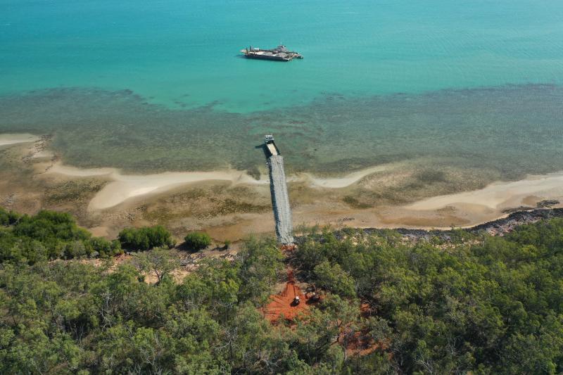 Aerial view of pier leading into the ocean