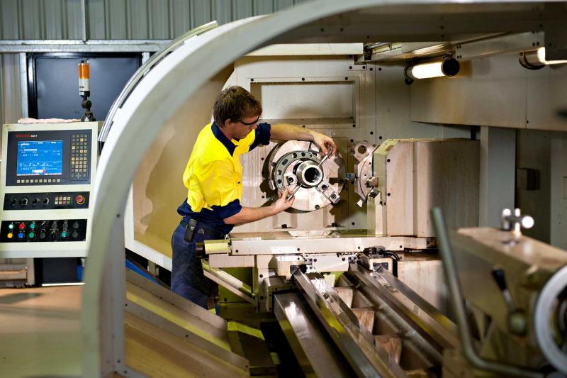 Man working on hydraulic machinery