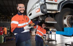 Vehicle mechanics underneath truck