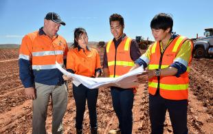 Workers study land management plans